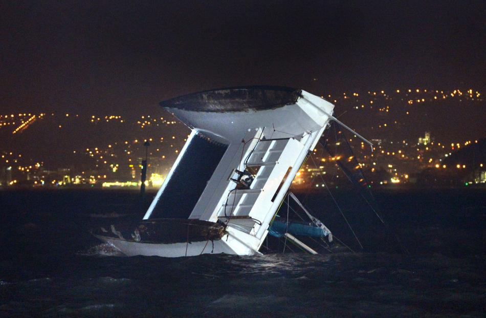 The wild weather capsized this catamaran in the Otago Harbour at Macandrew Bay last night. Photo by Stephen Jaquiery.