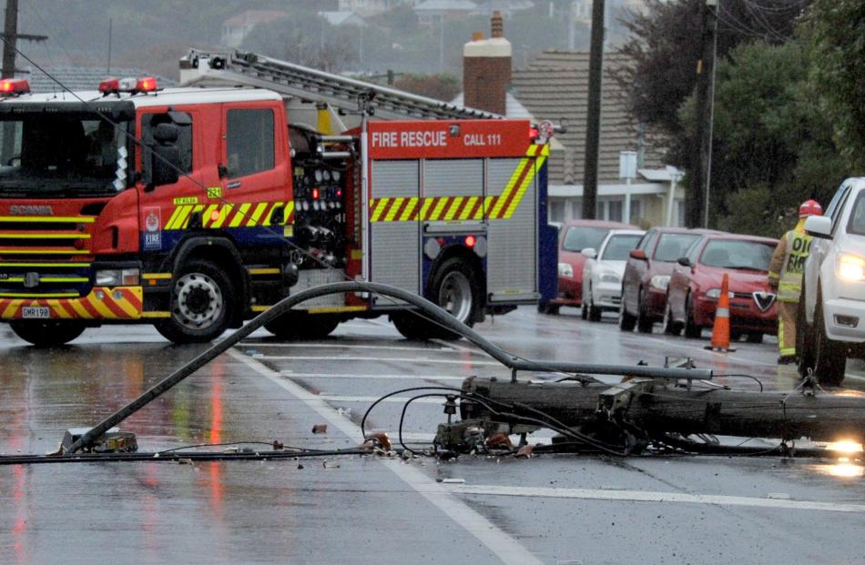The Fire Service assist Delta with fallen power lines in Forbury Rd yesterday. Photo by Craig Baxter.