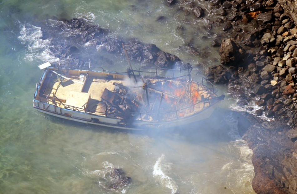 Smoke rises from the burning boat. Photo by Stephen Jaquiery