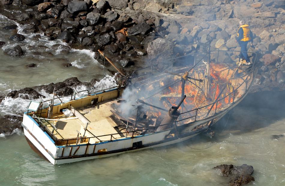 Smoke rises from the burning boat. Photos by Stephen Jaquiery.
