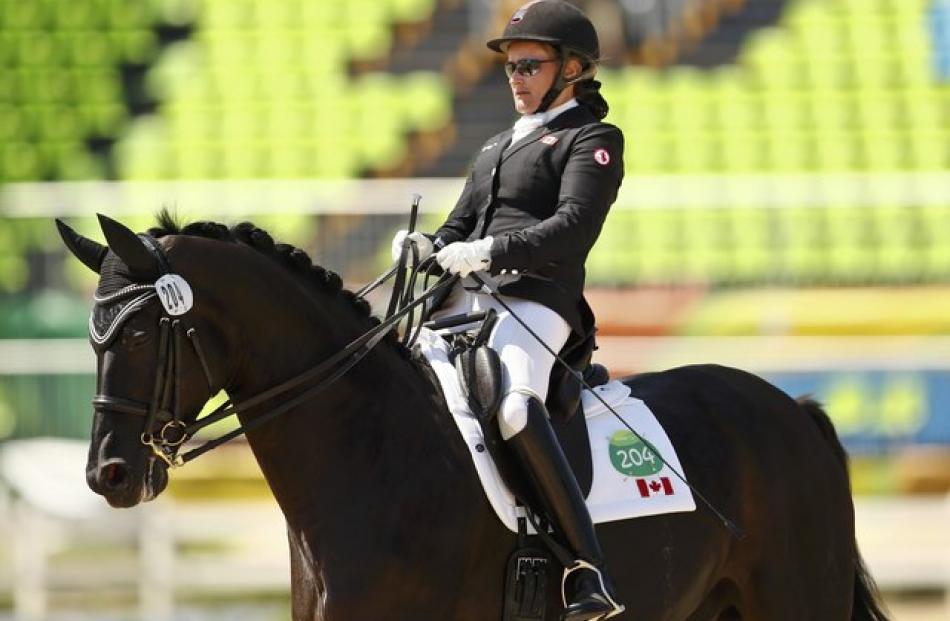 Lauren Barwick of Canada competes with her horse Onyx in the dressage event. Photo: Reuters