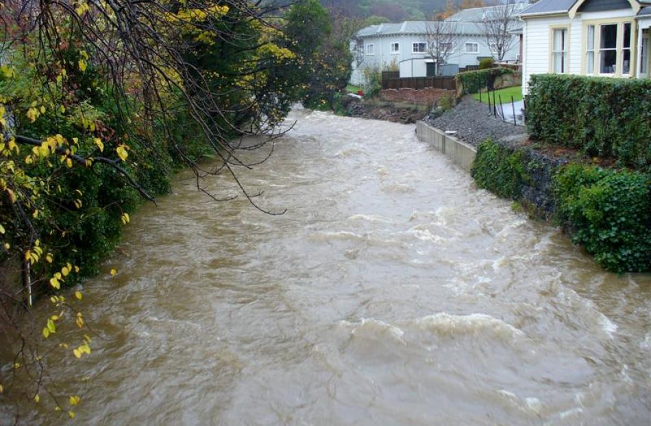 The Water of Leith running high near the University of Otago foot-bridge. Photo by Webfeatpix
