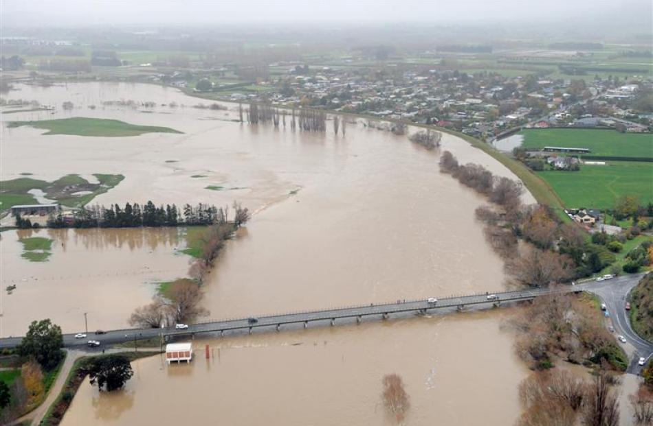 Protected by a floodbank, Outram is flanked by the flooding Taieri River on Saturday. Photo by...