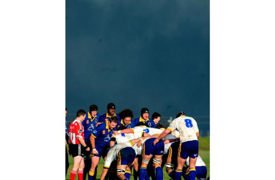 A scrum packs down against a very black sky at the Otago Air New Zealand Cup Trial teams game at...