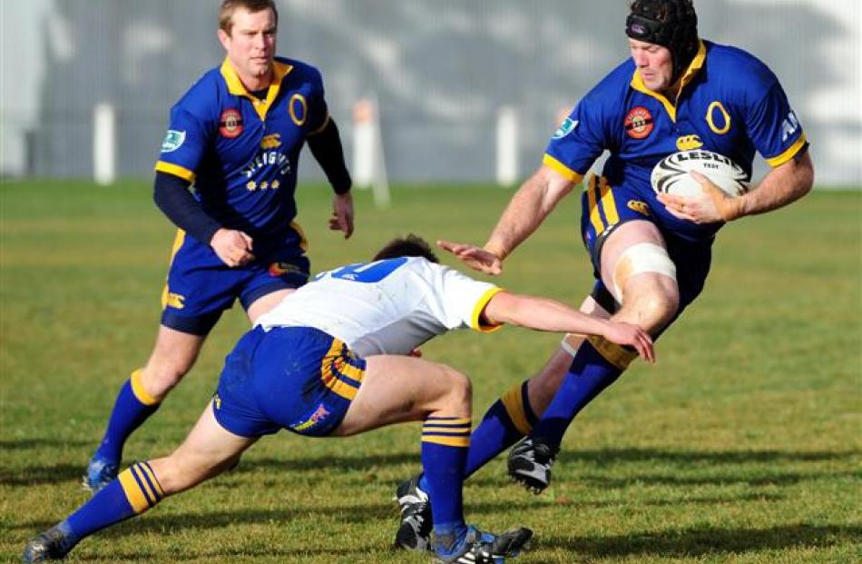 Jeremy Cave is tackled by Andrew Pararta at the Otago Air New Zealand Cup Trial teams game at the...