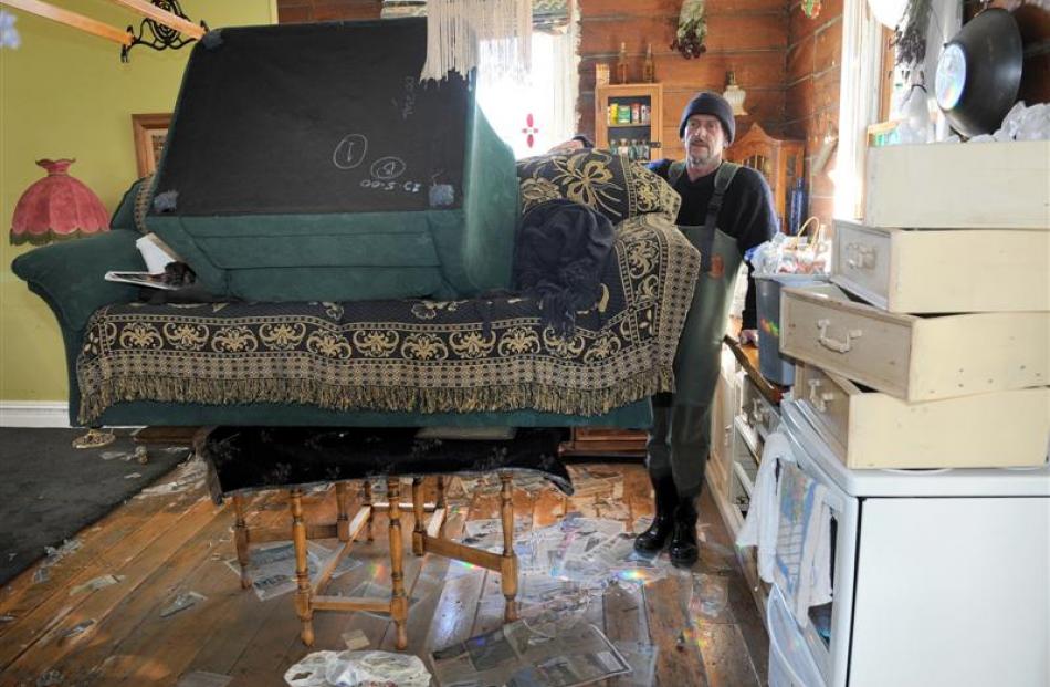 Kerrie Hooper in the couple's house yesterday. He put the couch on the kitchen table before...