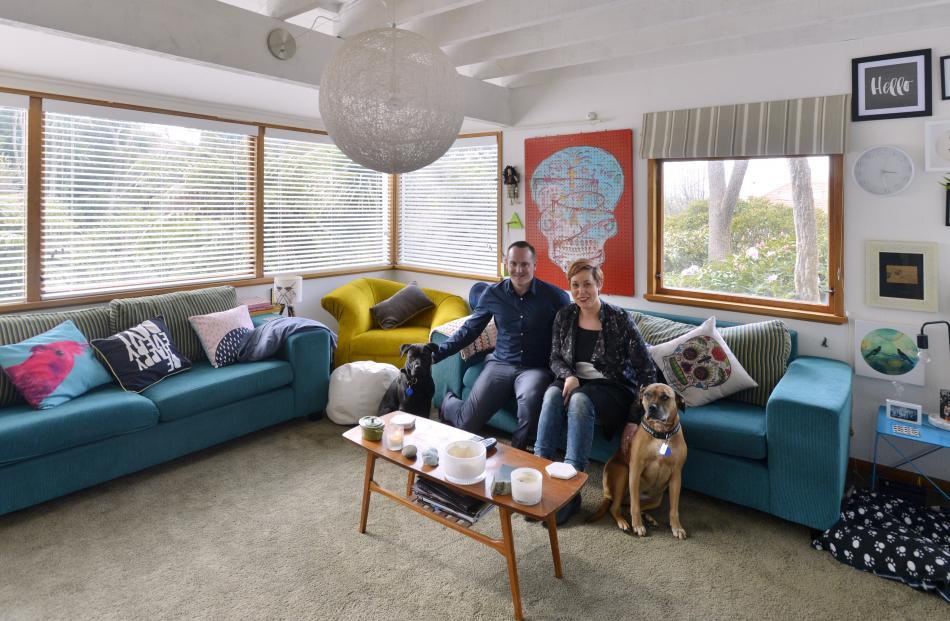 Scott and Ayla Hawkins, with dogs Vauxhall and Neka, sit in the living room of their St Leonards...