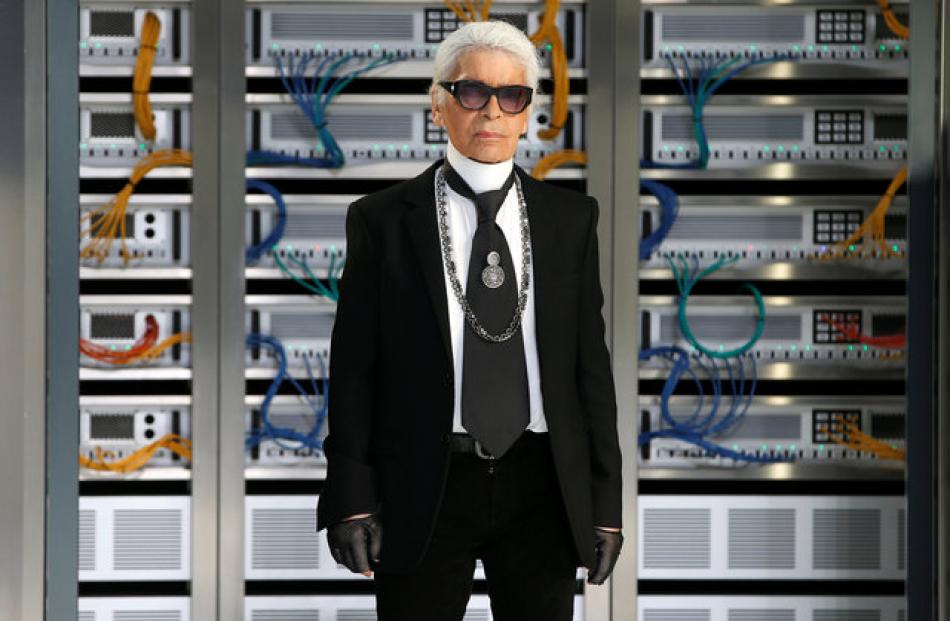 German designer Karl Lagerfeld appears at the end of his Chanel show which poked fun of the world...