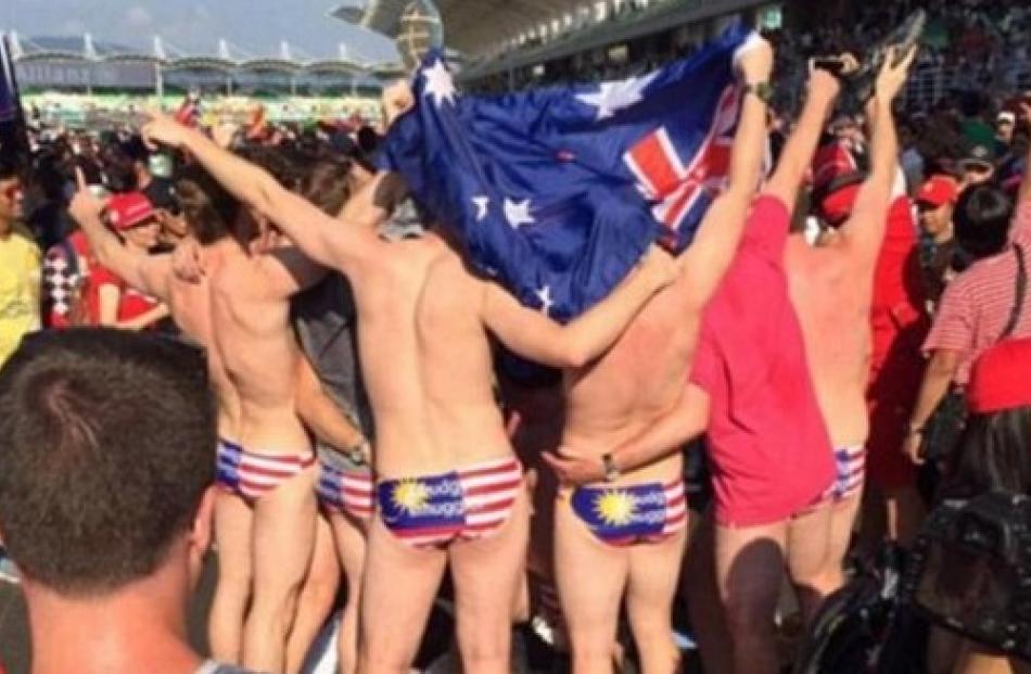 The Australians stripped down to their swimwear featuring the Malaysian flag at the F1 race....