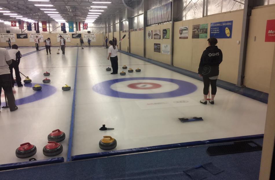 The Otago Boys’ (left) and Girls’ High  curling teams  compete against Kavanagh College at the...
