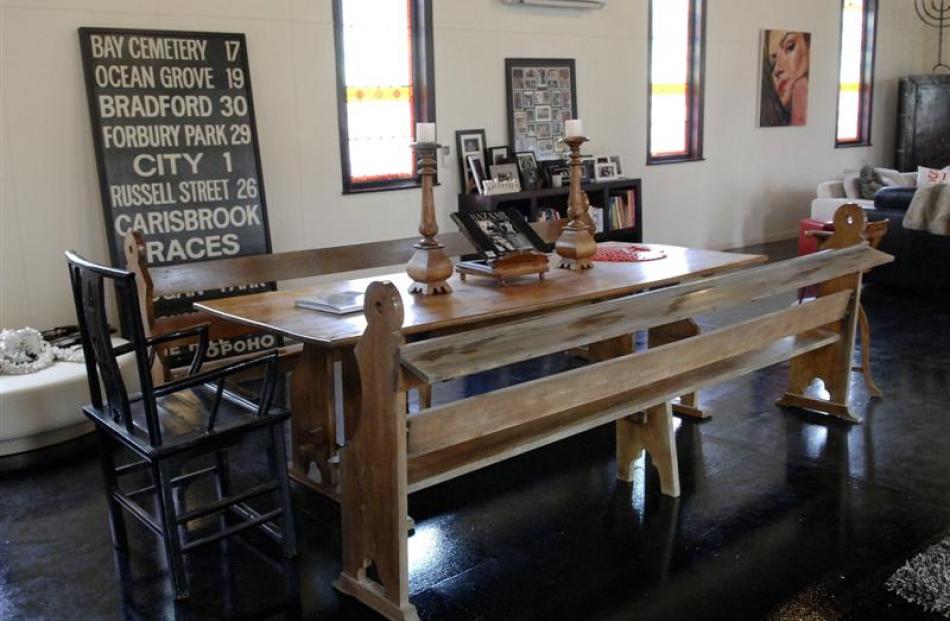 Pews at the dining table recall that this was once a church.