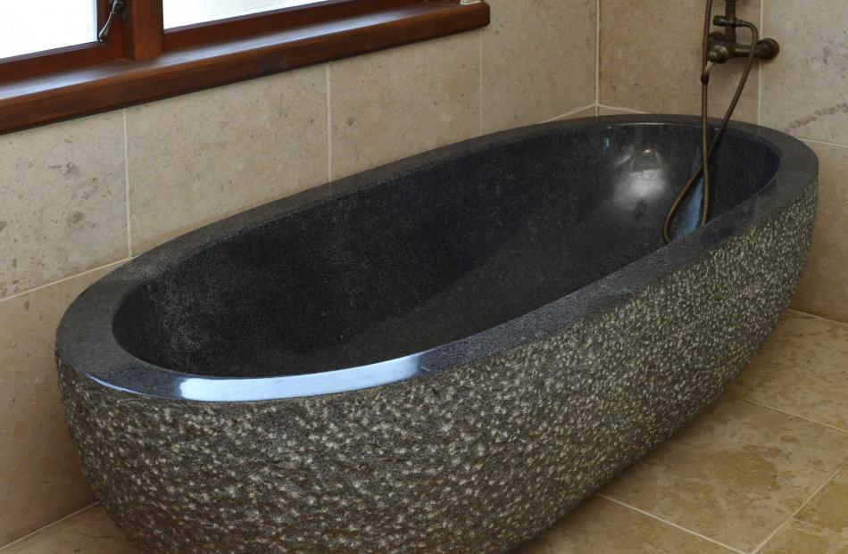 The bath was carved out of a single piece of granite and weighs more than a tonne. The owners say...