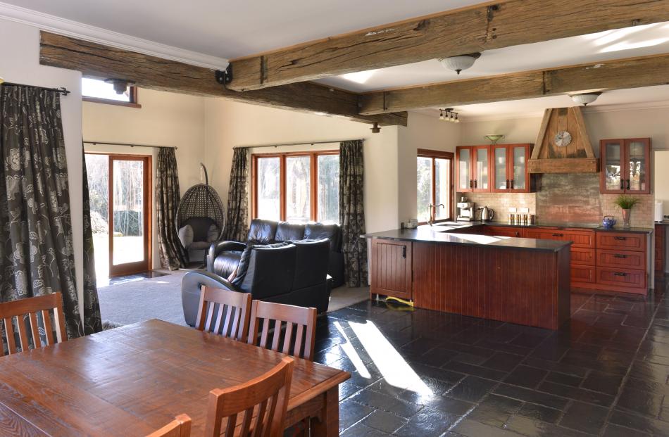 Weathered beams and slate flooring feature in the open-plan living area. When ordering a dining...