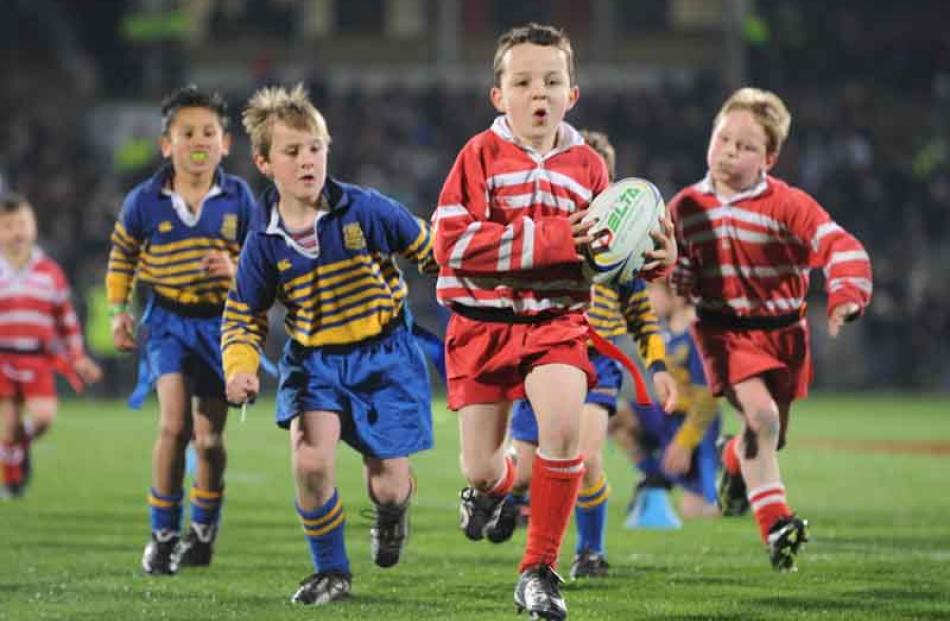 Billy Andrews, of the Pioneer Under 7 team from Gore, eludes the Taieri Under 7 defence in the...