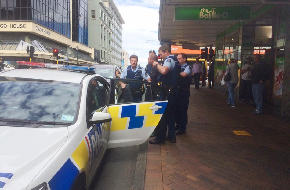 Police take a man into custody after an incident in Princes St yesterday. Photo by staff photographer.