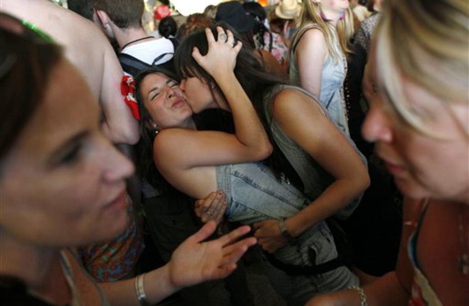 Partygoers share an embrace.