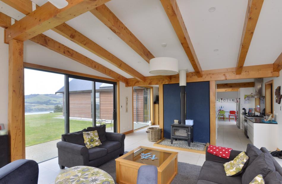 Macrocarpa milled on site is a feature of the open-plan living area. The dark blue colour behind...
