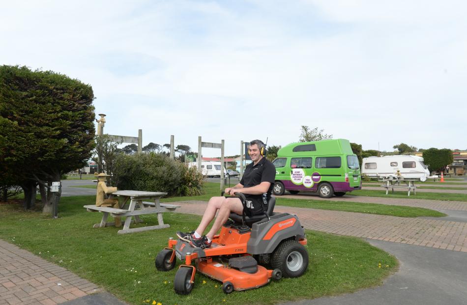 Dunedin Holiday Park manager Daniel Grubb on a ride-on mower at the park. Photo: Linda Robertson.