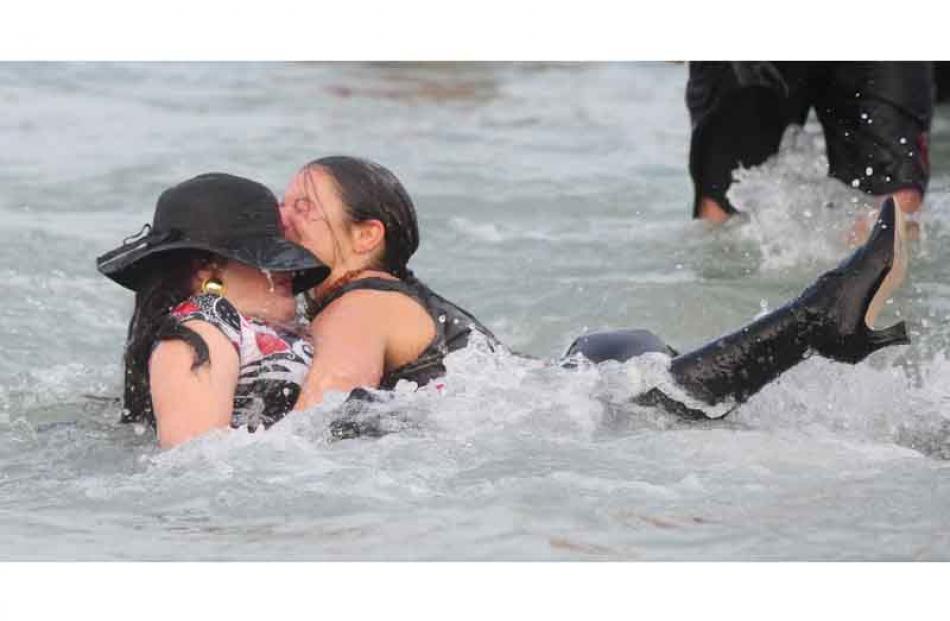 Linda McKie (left) and Jodi-Lee Williams lose their footing and fall into the chilly waters.