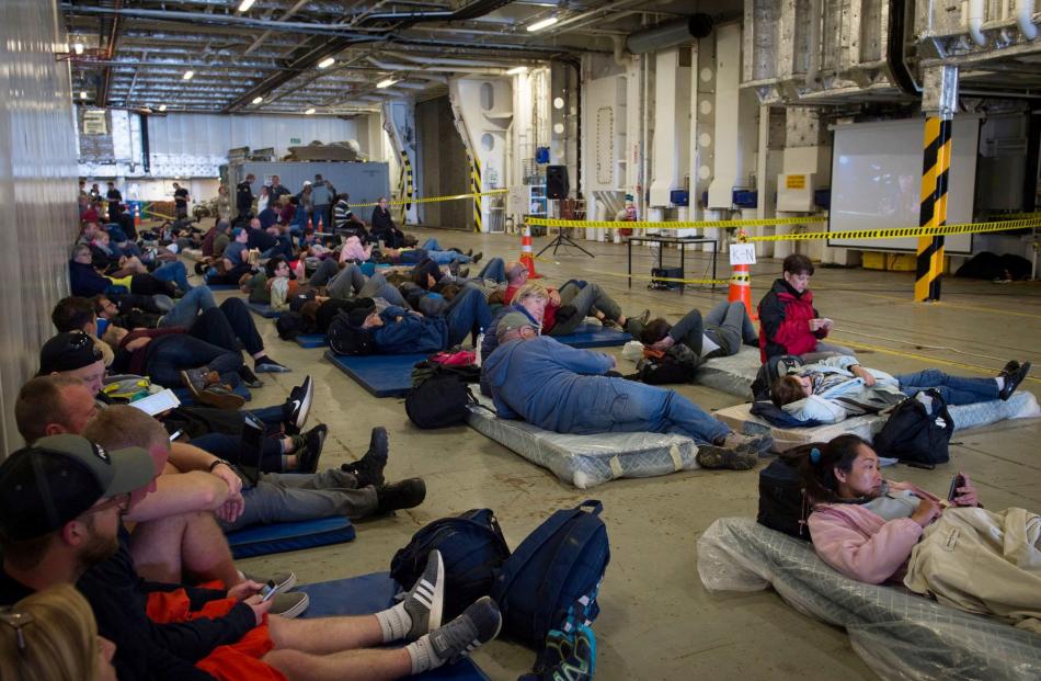 Evacuees who had been stranded in the earthquake-affected Kaikoura rest aboard Royal New Zealand Navy ship HMNZS Canterbury. Photo from Reuters.