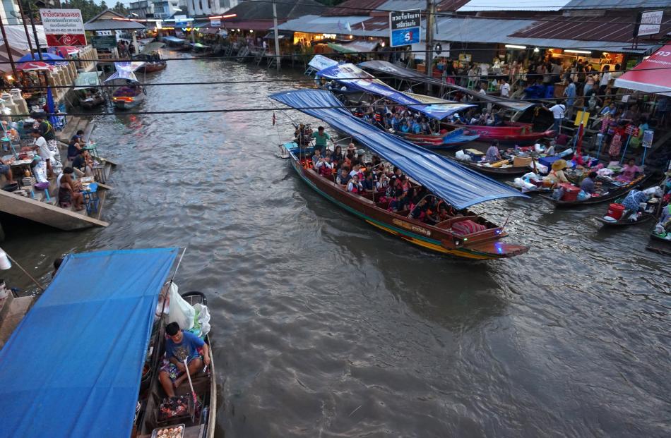 Thailand’s floating markets are a colourful scene at twilight.


