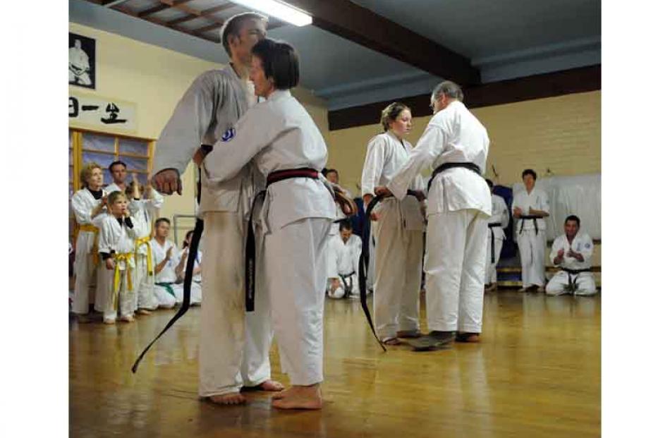 Steve and Zoe receive their black belts from Kyoshi Sandra Wiggins and Sensei Sean Brosnahan.