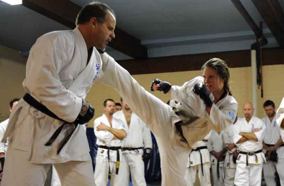 Zoe stretches to connect with a kick to the head of Sensei Sean Brosnahan.