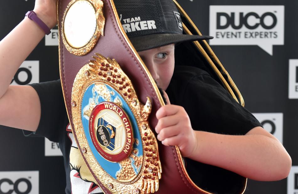 Harper Wilson (7) tries on the belt.