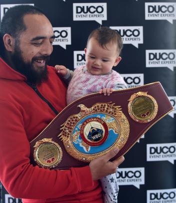 Che Cooper and Ivy Cooper-Waldron (9 months) take hold of  the WBO heavyweight belt custom-made...