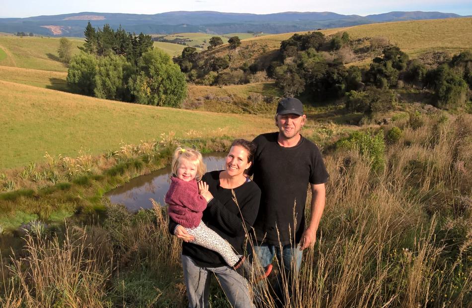Robin and Emma Wightman, with Matilda (4), hosted a field day on their Tuapeka West farm to showcase their forestry and plantings recently. They won the South Otago Farm Forestry's Peter and Pearl Moffat Award earlier this year and are pictured beside a p