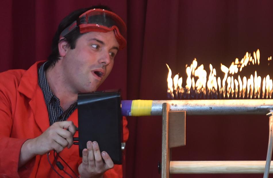 Amadeo Enriquez Ballestero shows what happens to the flames in a pipe filled with burning gas, when the song Let It Go from the movie Frozen is played into one end. Photos by Peter McIntosh.