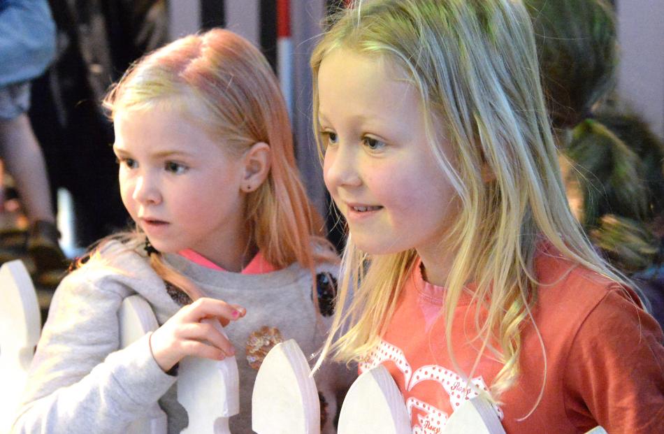 Taking a keen interest are youngsters Sara Tucker (left) and Lily Gordon (both  6), both of...
