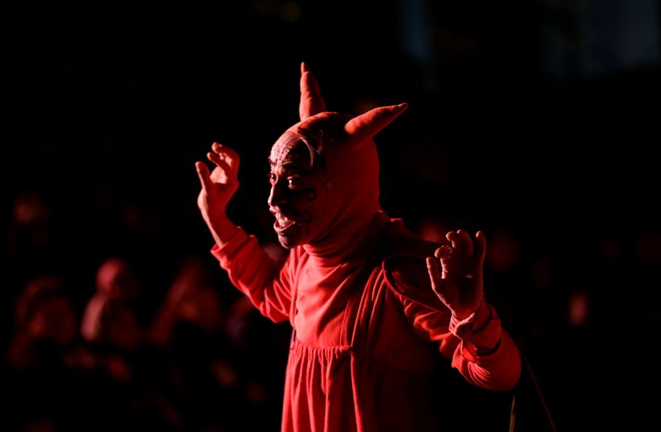 An actor dressed as the devil participates in a traditional Christmas presentation, known as the...
