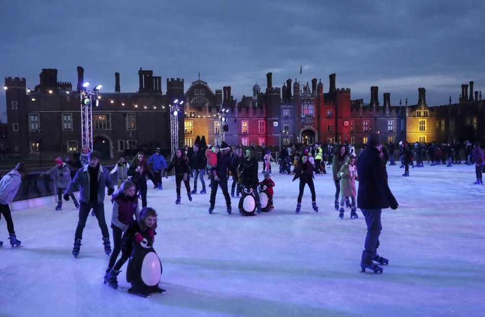 People skate on the ice rink at Hampton Court Palace in London. Photo: Reuters