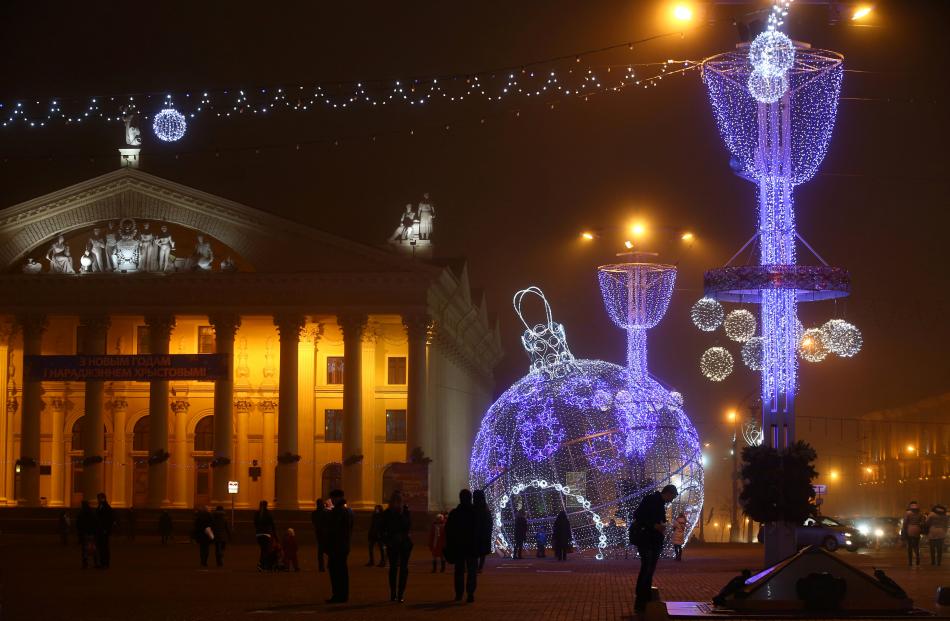 A giant bauble lit up in Oktyabrskaya Square in Minsk. Photo: Reuters