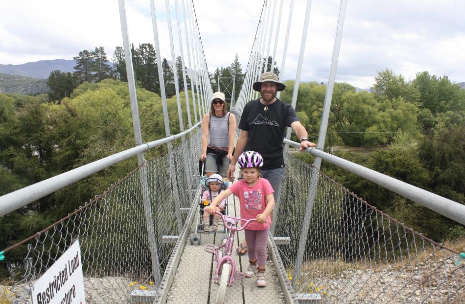 Crossing the swing bridge over the Hawea River at the Albert Town end of the Hawea River Track ...