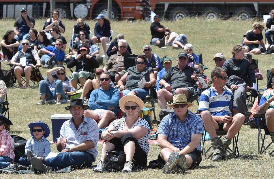 The crowd watches the action on a hot and blustery afternoon.