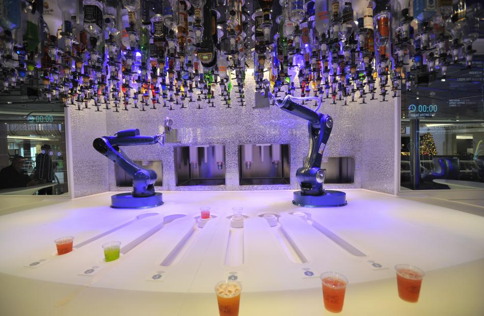 Robot bar-folk prepare drinks from 144 bottles of spirits at their disposal.