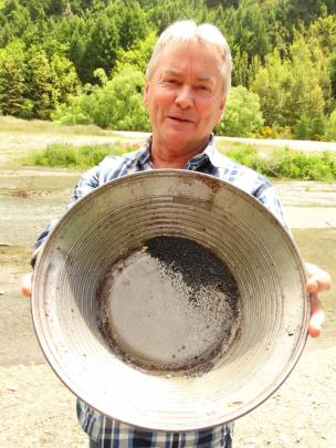 Justin Eden, of Arrowtown, shows how nuggets of gold can be spotted while panning. Photos by Louise Scott.