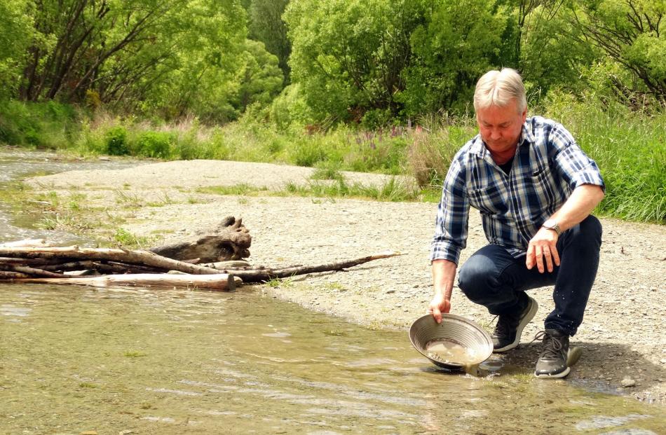 Justin Eden gold panning on the Arrow River, Arrowtown.