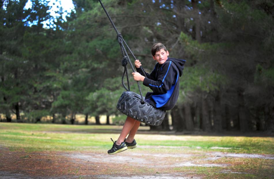 Jalen Mingins plays on a tyre swing at Scott Hall yesterday. Photos by Christine O'Connor.
