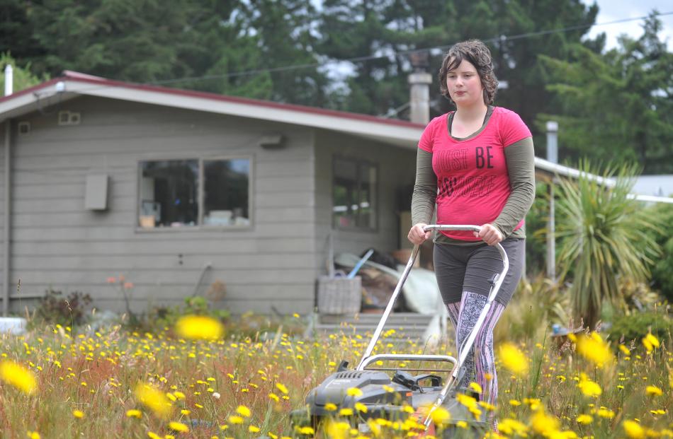 Briar Matthews (12) spends time trimming lawns. 
