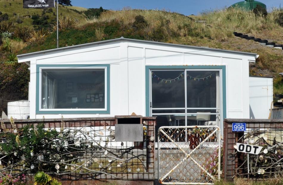 A silver fern flag flies at a house in Harington Point.