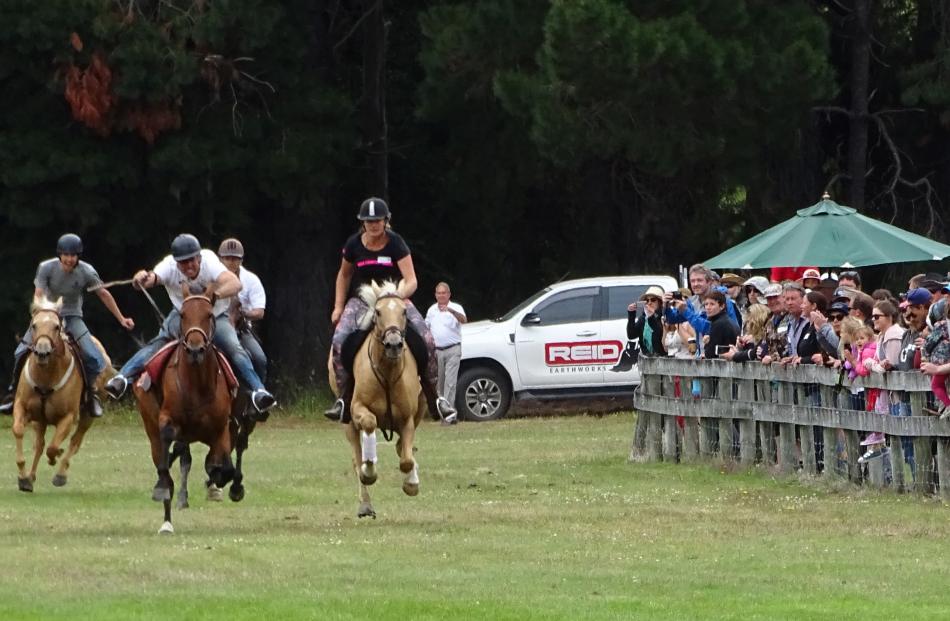 Riders in the relay event, part of the Glenorchy Races, head down the finishing straight on...