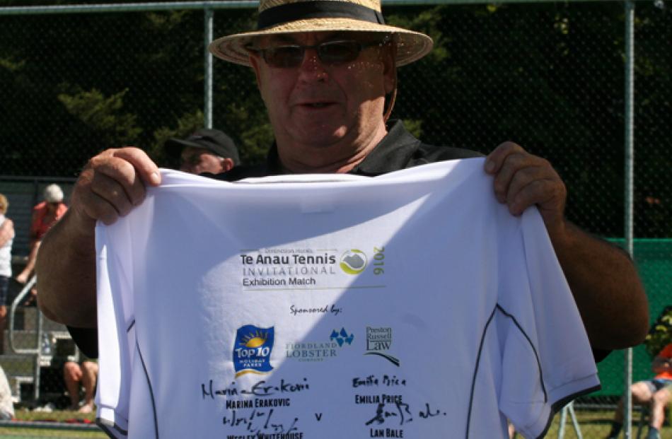 Ian Willans, of Te Anau, holding the signed t-shirt ready for auctioning. Ian was one of the...