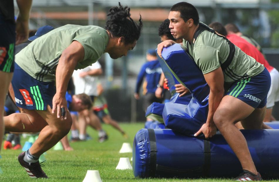 Aki Seiuli prepares to run into a hit shield held by Daniel Lienert-Brown at the session. PHOTOS:...