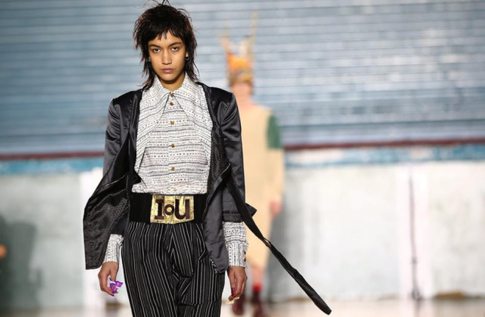 Women's jackets had asymmetric cuts or exaggerated shoulders. Shirts had large collars and...
