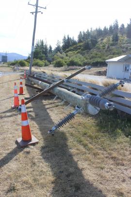 A power pole is blown over on the outskirts of Cromwell.