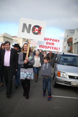 Waitaki District Councillor Melanie Tavendale marches with Lachlan Wright (7) and 2500 others in...
