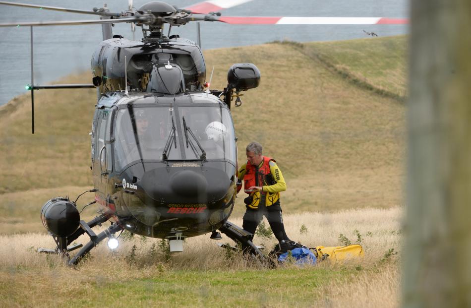 A water rescuer climbs on board the Otago Regional Rescue Helicopter, which was involved in the...